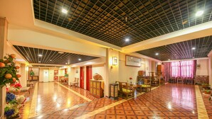 A spacious lobby with a patterned floor, a high ceiling with a grid design, and a reception area with a sign. - Xian Ancient City Youth Hostel (Xi'an)