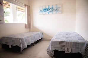 A room with two single beds, a window with curtains, a wall-mounted artwork, and a tiled floor. - Lacqua DiRoma II Via Caldas (Caldas Novas)