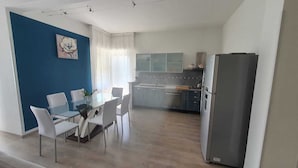 A modern kitchen with a dining area.