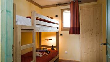 Cozy single-room accommodation with a bunk bed arrangement and functional design.