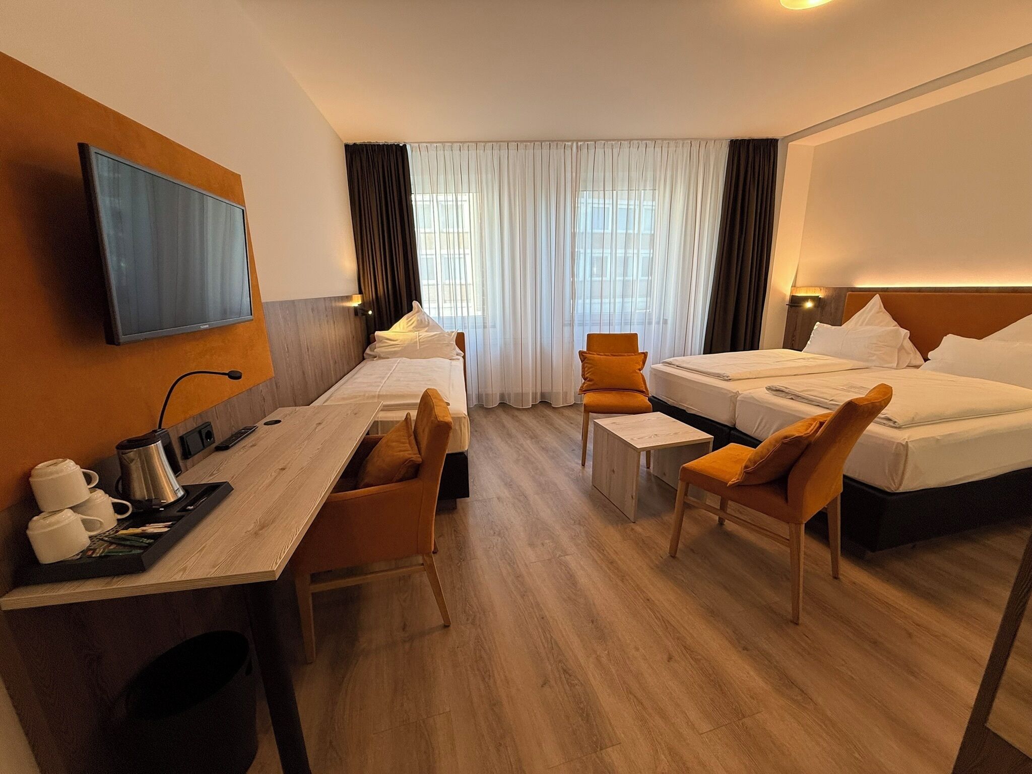 Standard Triple Room | Living area | 32-inch LCD TV with satellite channels, TV