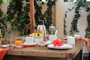 A breakfast table with coffee, tea, fruit, and eggs. - House of Spice (Zanzibar Town)