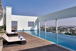 Outdoor pool, open 7 AM to 7:00 PM, pool umbrellas, sun loungers