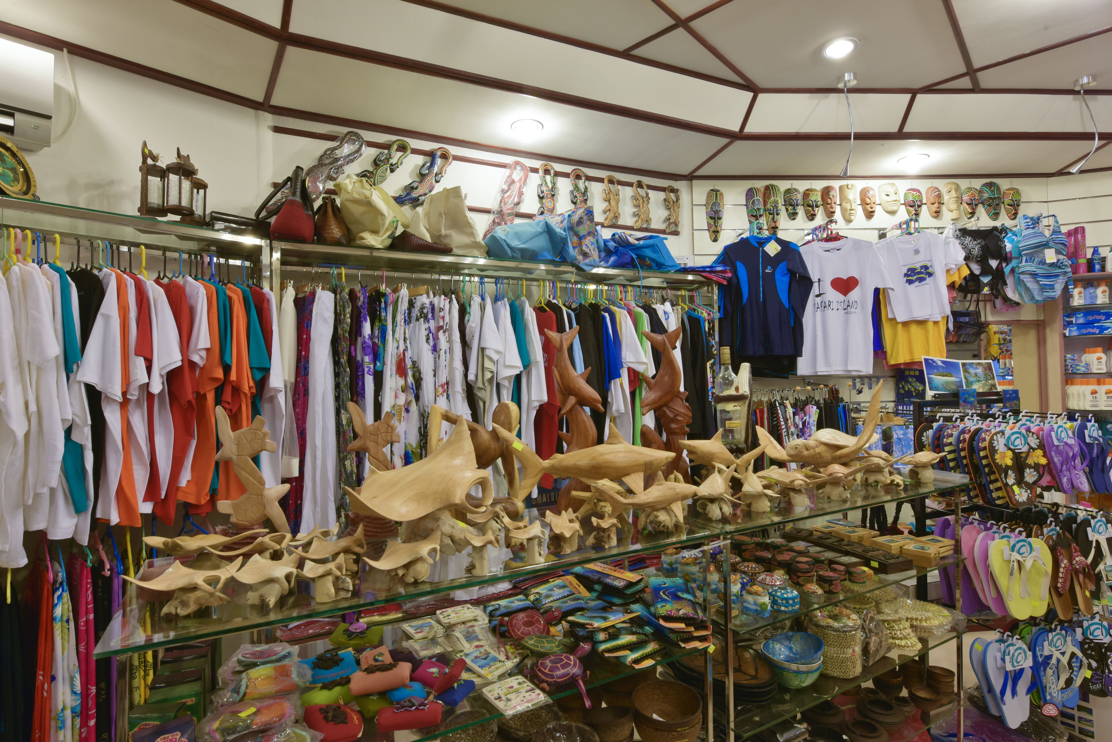 A store with various items on display including clothing, masks, and decorative objects.