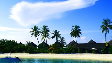On the beach, white sand, sun loungers, beach towels