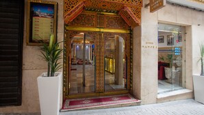 A hotel entrance with ornate designs, a reception area, and a signboard. - MAMORA BAY (Tangier)