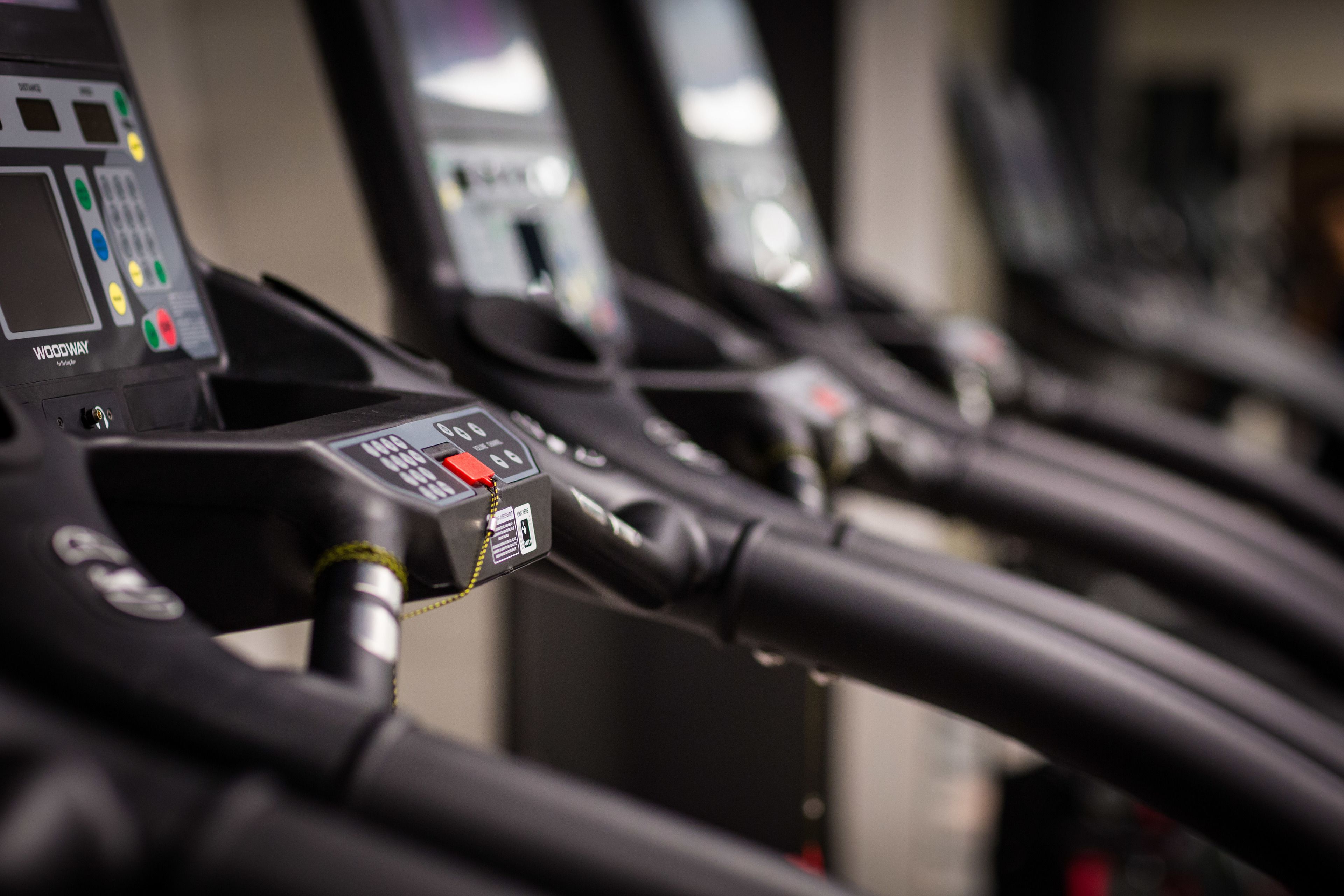A treadmill control panel with various buttons and a display screen.