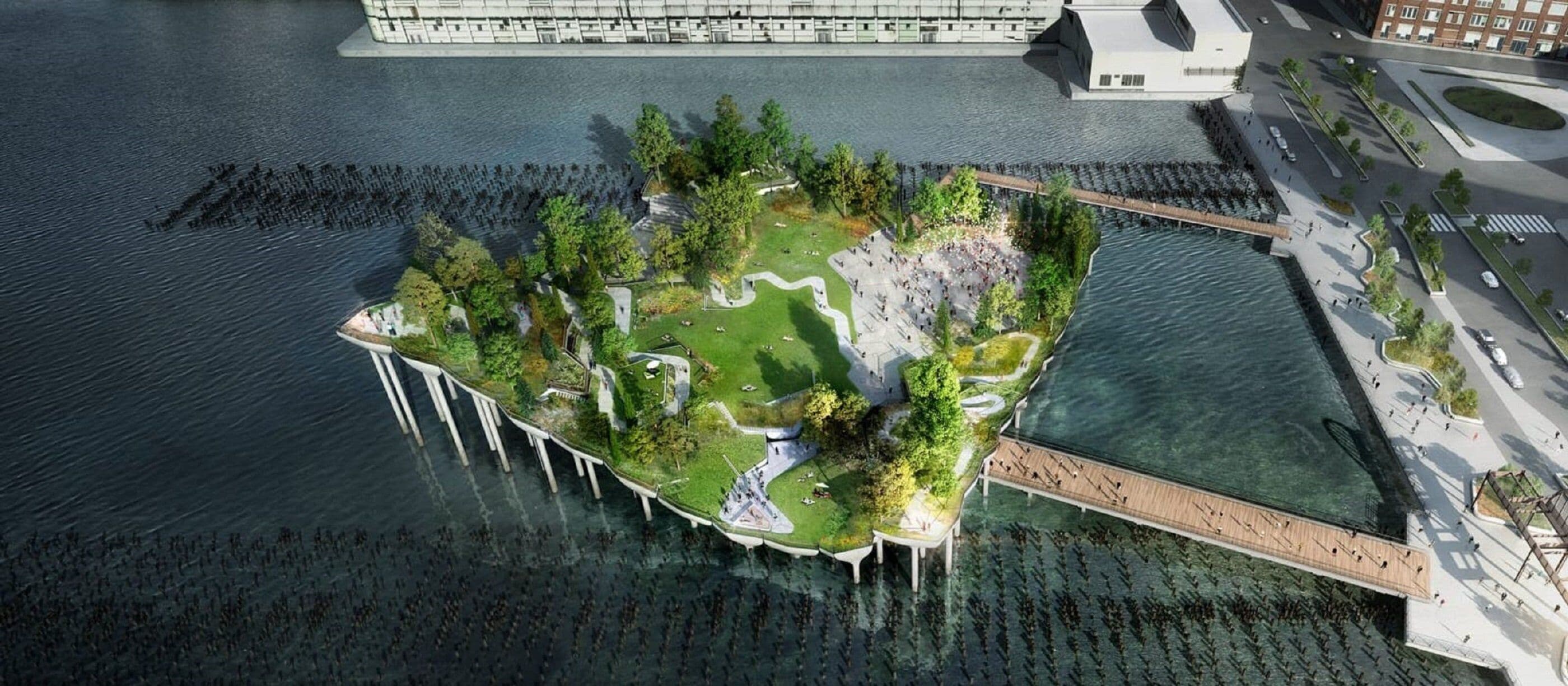 An aerial view of a waterfront property with a central island featuring a park, pathways, and a bridge connecting to the main land.