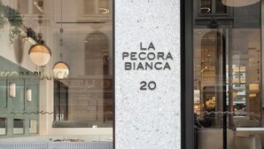 En butik med ett skyltfönster där det står ”LA PECORA BIANCA 20”.