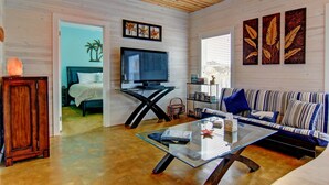 A living room with a TV, sofa, and coffee table. - 6 On The Beach VW6 (Port Aransas)
