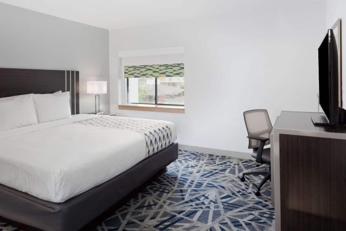 Desk, laptop workspace, blackout drapes, iron/ironing board