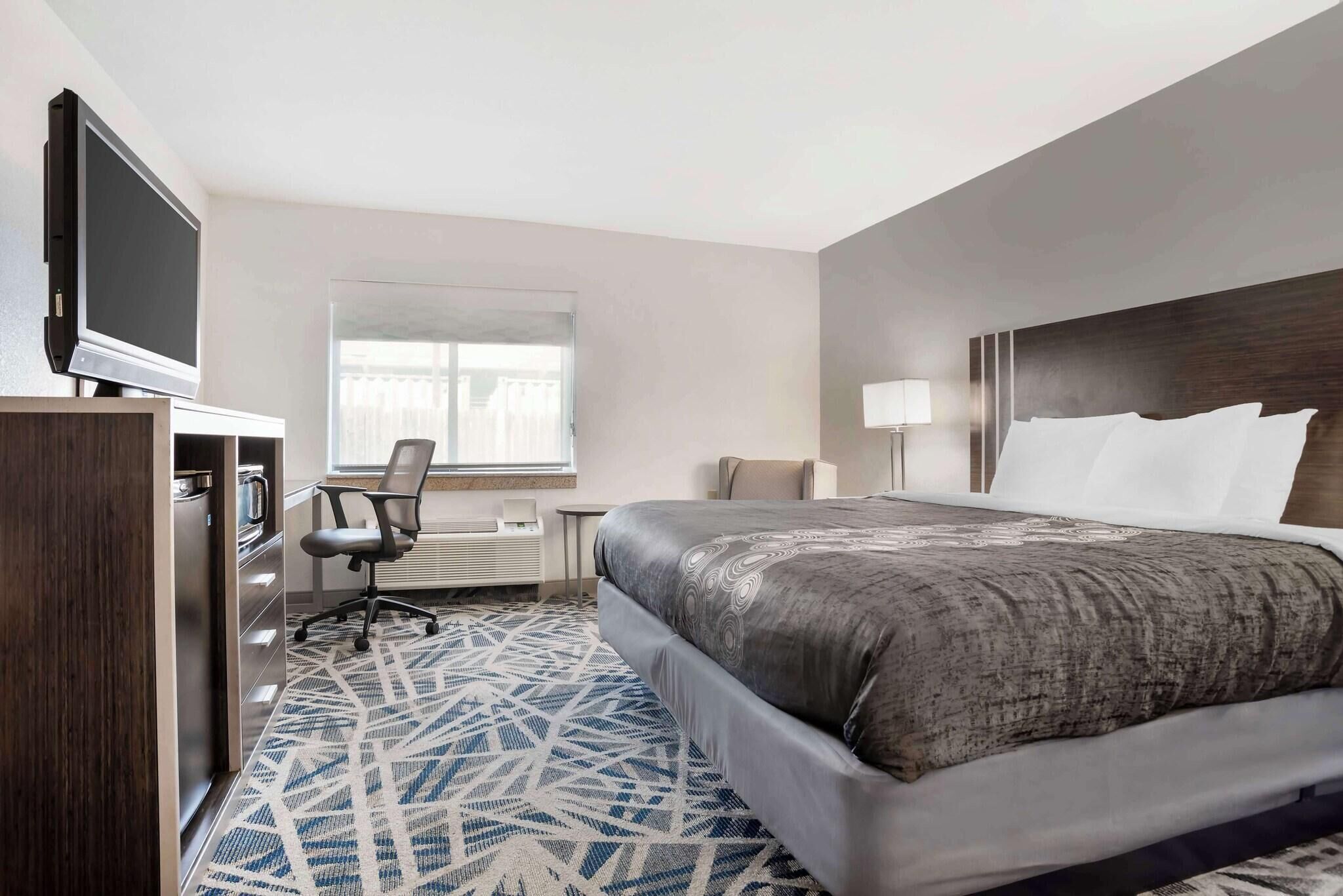 Desk, laptop workspace, blackout drapes, iron/ironing board