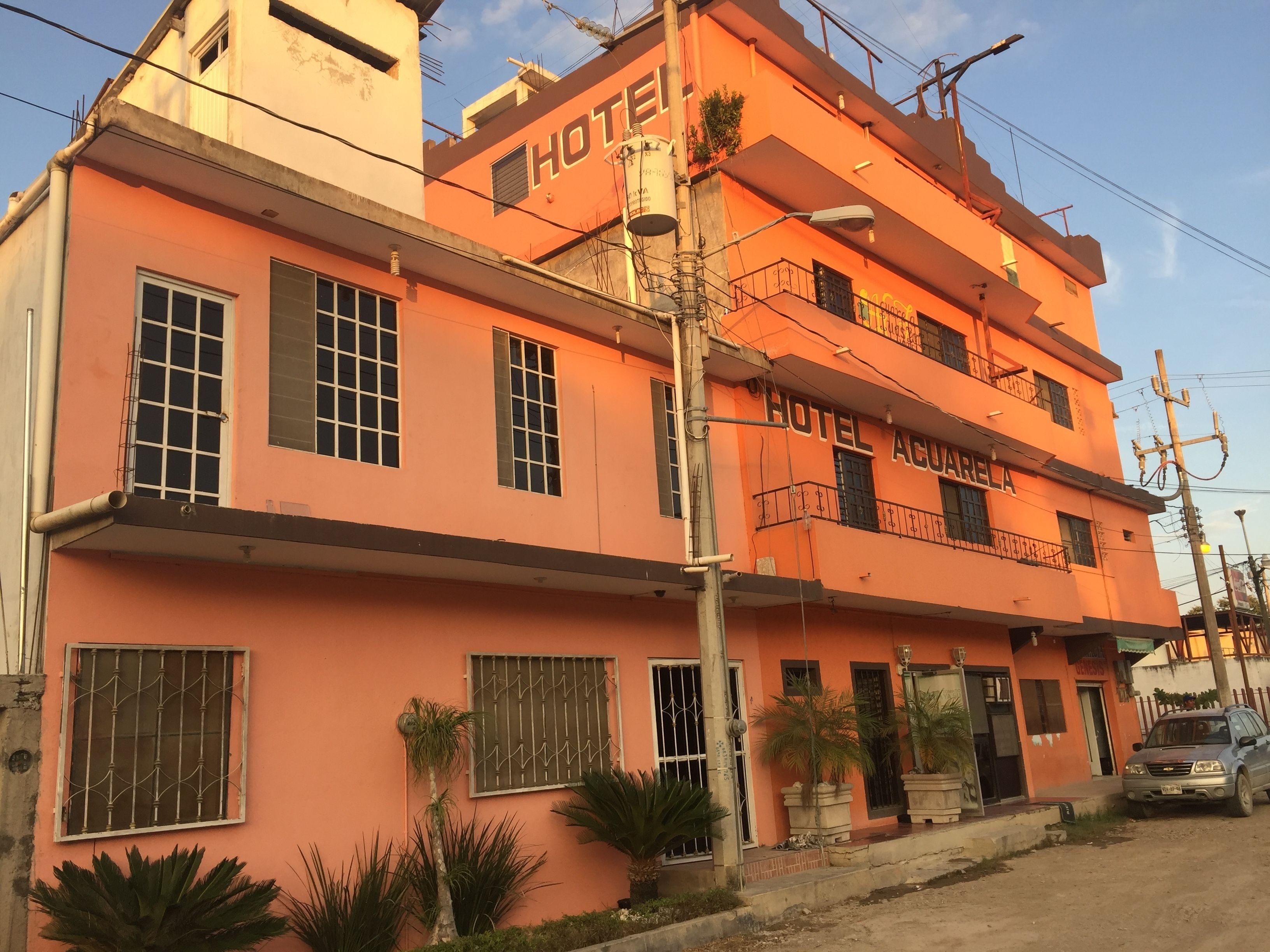 A multi-story building with the sign "HOTEL ACUARELA" prominently displayed.