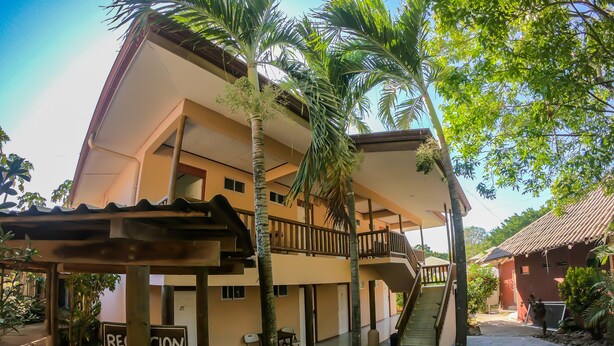 A two-story building with a covered outdoor area, a staircase, and a sign that reads "RECEPTION".