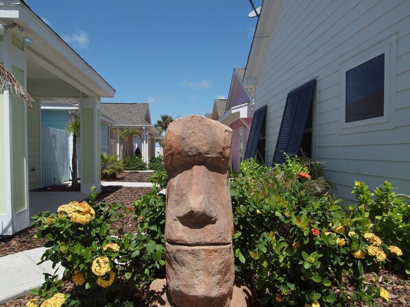 Surrounded by lush greenery and vibrant flowers, this residential area offers a serene atmosphere.