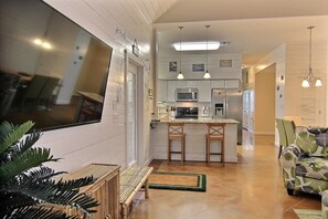 Enjoy meals in the kitchen with a central island, bar stools, and a dining area featuring a bench and chairs.