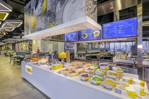 A buffet area with various food options and a drinks menu. - YELLO Hotel Harmoni Jakarta (Jakarta)
