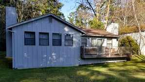 A single-story house with a front porch and a small deck.