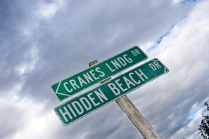 Street signs for 'CRANES LNDG DR' and 'HIDDEN BEACH DR'. - Sea Forever Cabin (Greenbank)