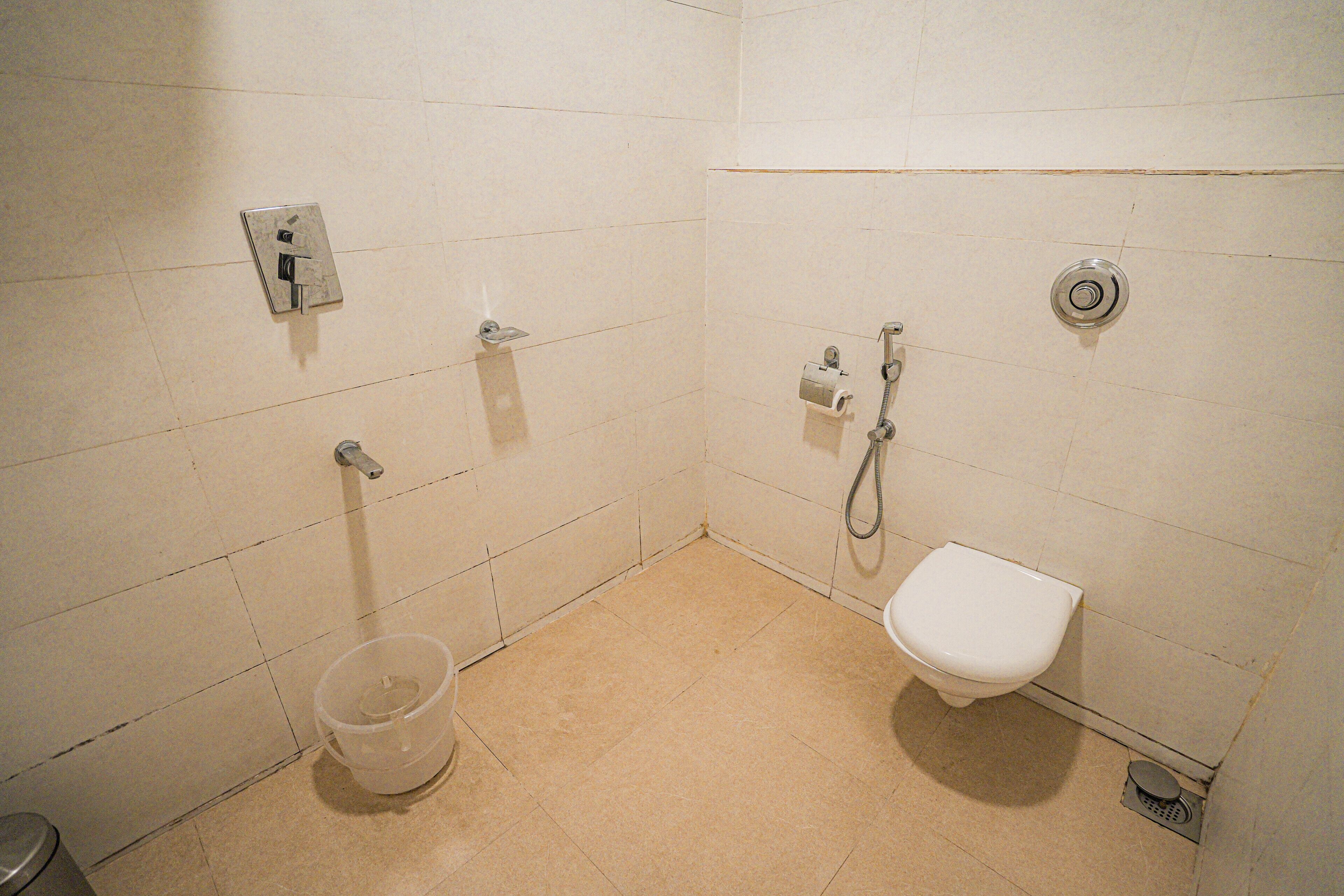 A small, clean bathroom with a toilet, bidet, and shower.