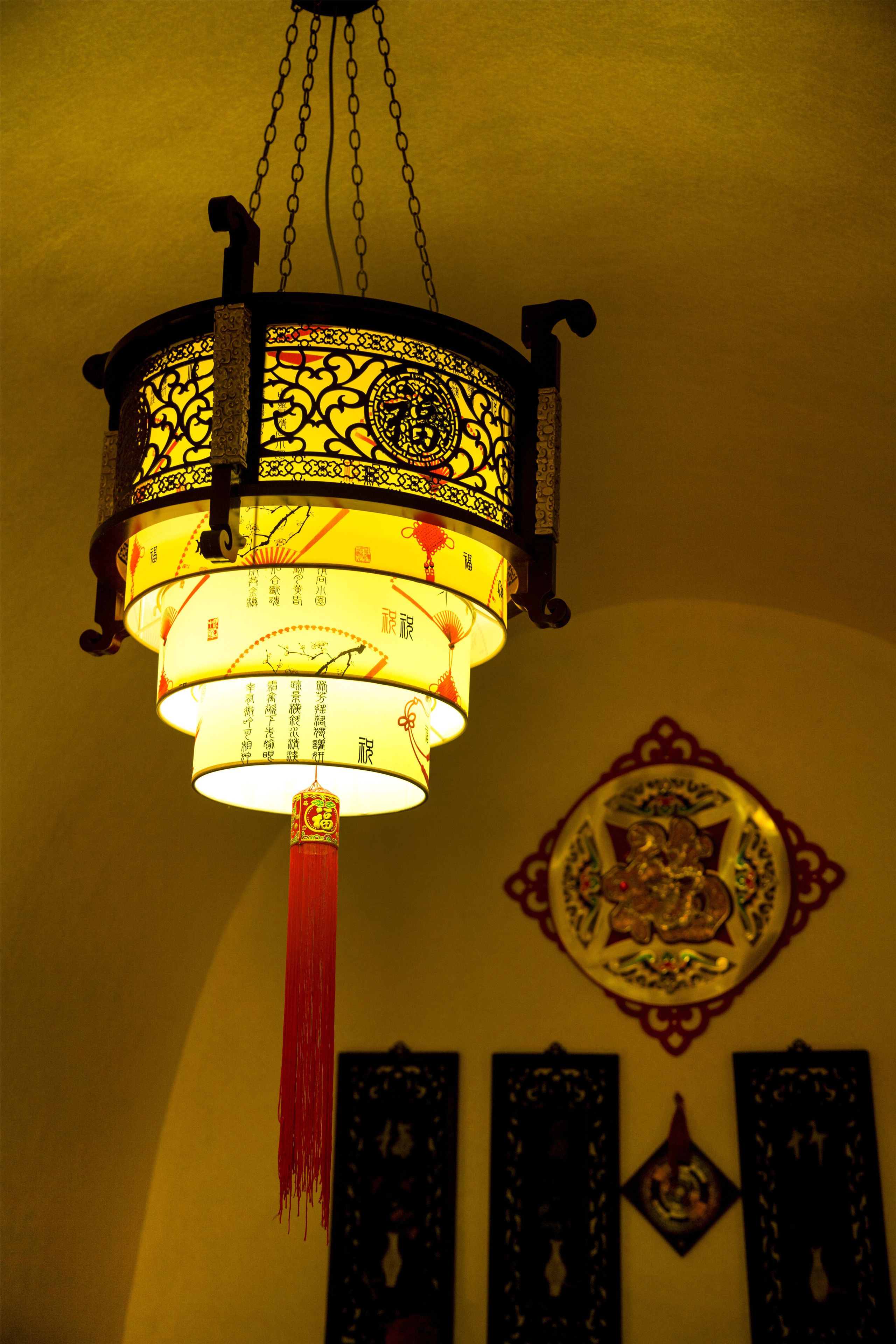 A traditional hanging lantern with intricate designs and Chinese characters.