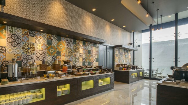 A modern kitchen with a tiled backsplash, a marble countertop, and a variety of kitchen appliances and utensils. - Hotel 88 Kedungsari by WH (Surabaya)