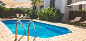 Seasonal outdoor pool, pool umbrellas, pool loungers