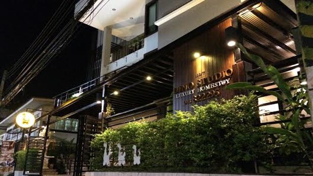 A modern building with a sign that reads "LUXURY HOME STAY 2023". - Dino Studio (Kalasin)