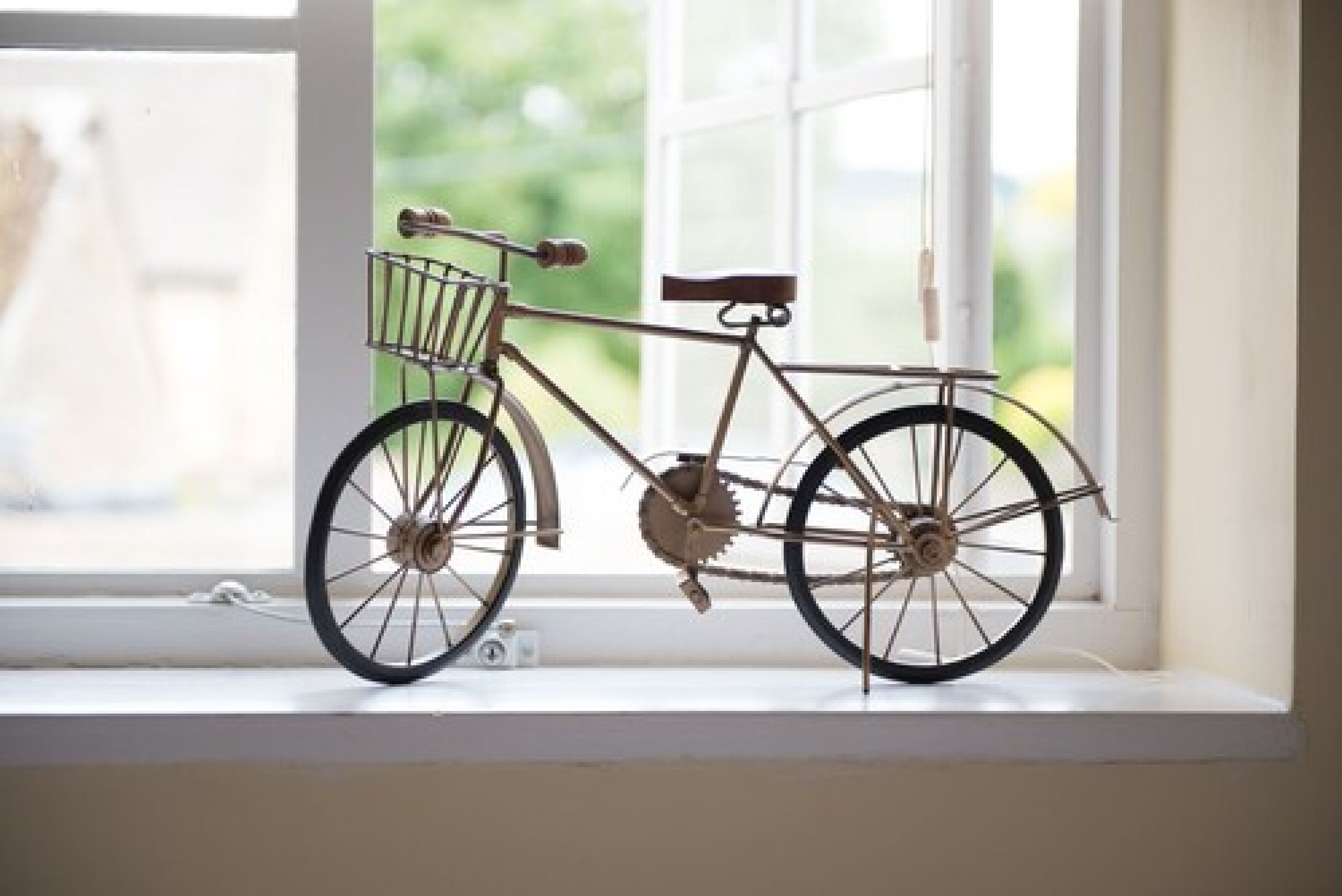 Una bicicleta apoyada en el alféizar de una ventana.