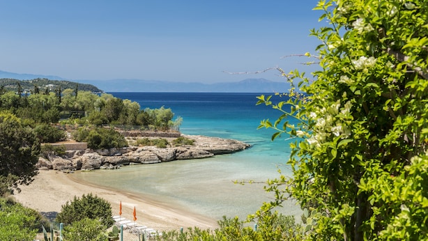 A coastal landscape with a beach, clear water, and rocky outcrops. - Electra Beachfront Villa (Ermionida)