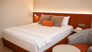 A hotel room with a bed, bedside table with a phone, and a chair. - NFK The House Hotel (Konyaalti)
