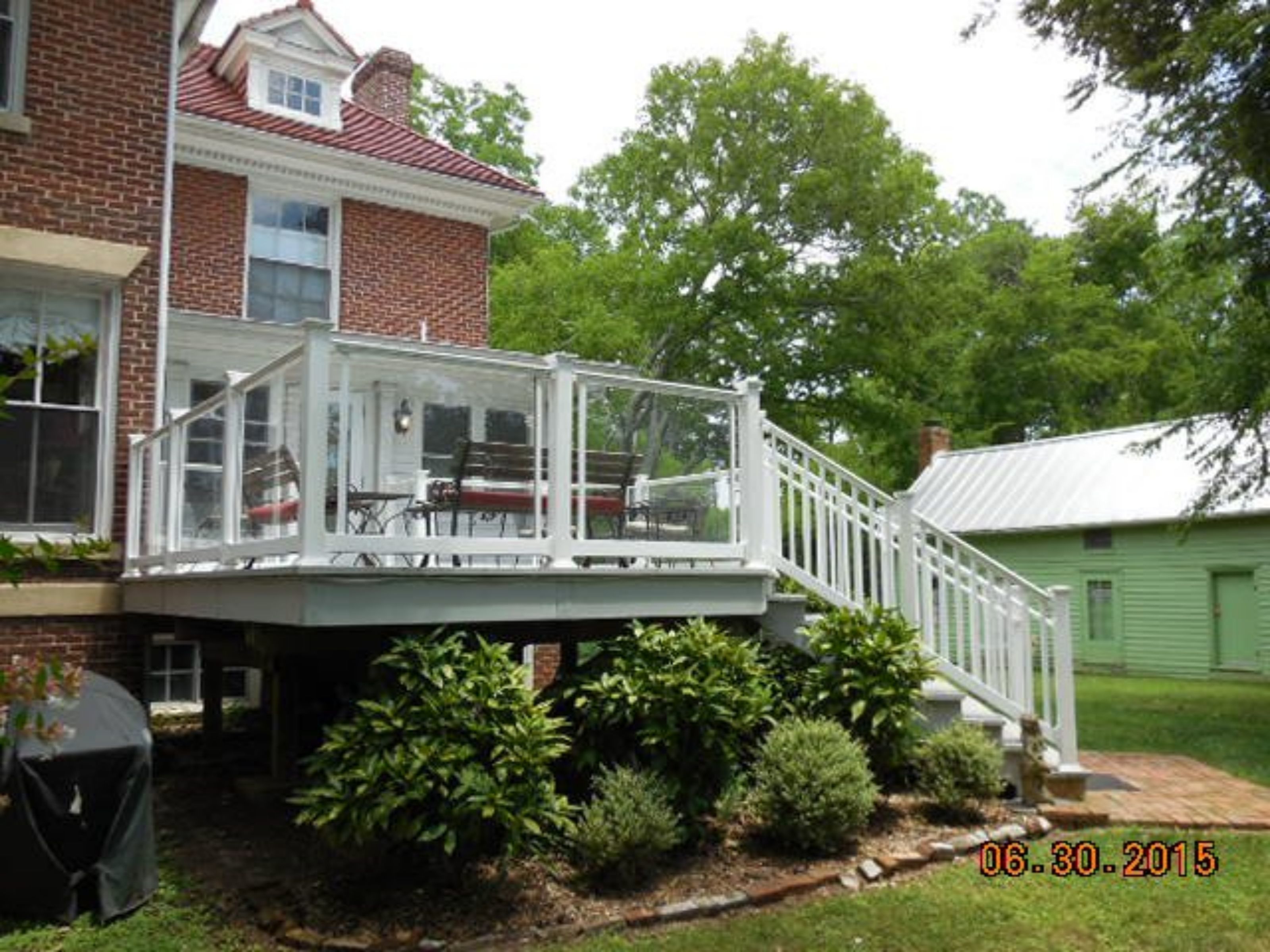 A two-story house with a covered patio area.