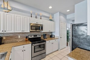 Fridge, microwave, stovetop, dishwasher - Asiago Vacation Rental at Lely Resort. Newly Furnished 2-Bedroom Condo with Stunning Lake & Golf Views. Spacious Retreat with Private Lanai, Resort Pool, Hot Tub and Gym Access (Naples)