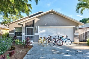Ein Wohnhaus mit Garage, Auffahrt und einer Reihe Fahrräder, die davor geparkt sind.