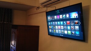 Televisor de pantalla plana montado en la pared mostrando diversas aplicaciones.