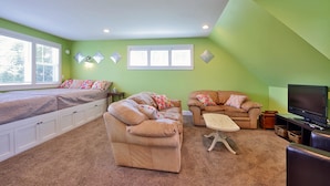 A room with a bed, two sofas, a TV, and a window. - The Lookout at Cranes Landing (Greenbank)