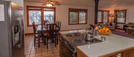 A modern kitchen with a central island, a stove, and a refrigerator.