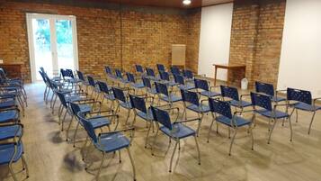 A room with rows of blue folding chairs arranged for an event.
