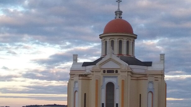 A large church with a prominent dome and bell tower.