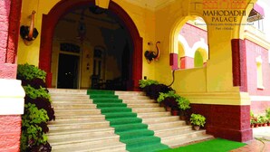 A staircase leading to a building entrance with a sign reading "MAHODADHI PALACE A Beach View Heritage Hotel Puri - Odisha." - Mahodadhi Palace (Puri)