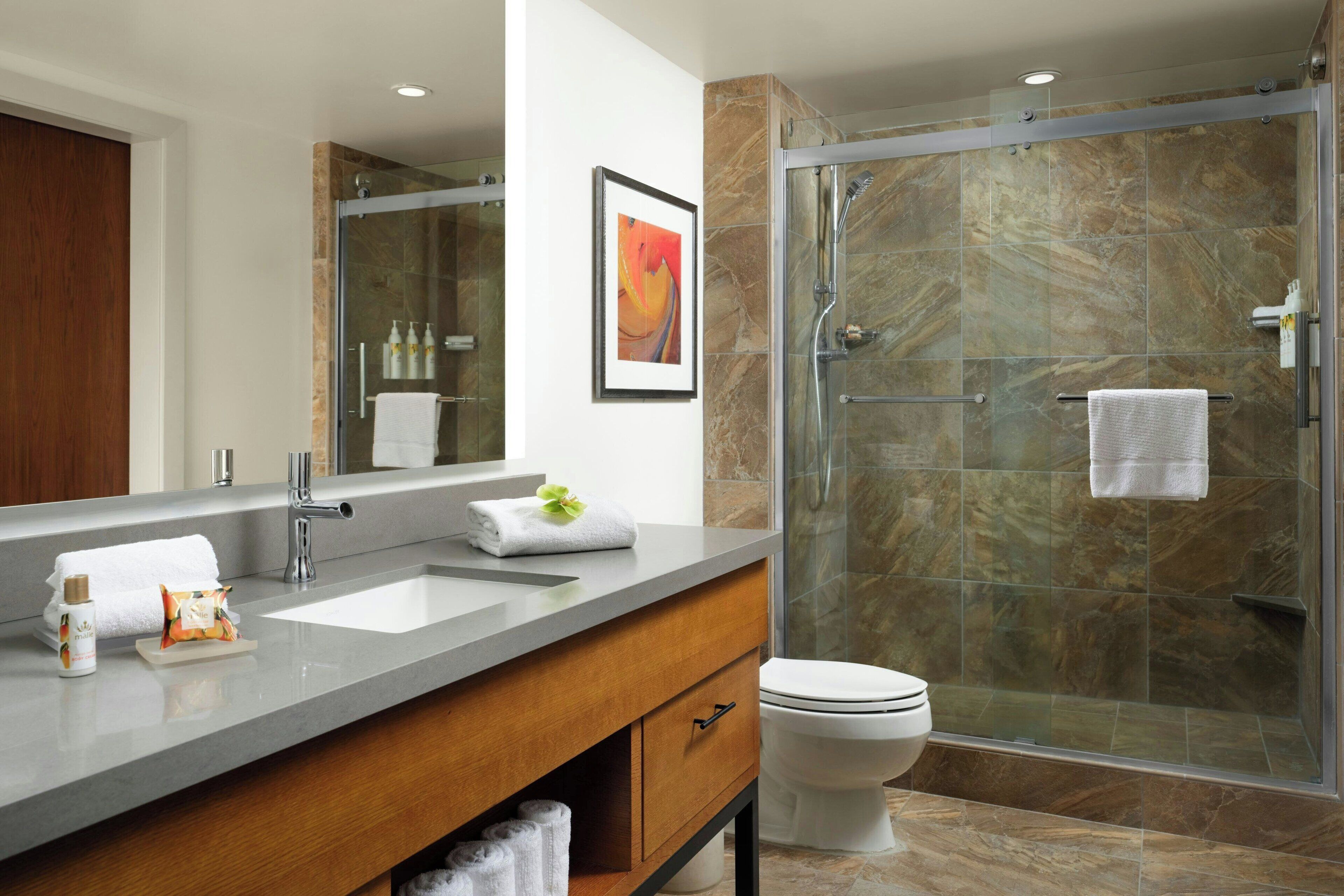 designer toiletries, hair dryer, towels, soap