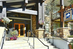 A building with a stone facade, a wooden entrance, and a sign indicating 'Fraser Crossing'. - Fraser Crossing 3319 1 Bedroom Holiday Home by Winter Park Lodging Company (Winter Park)