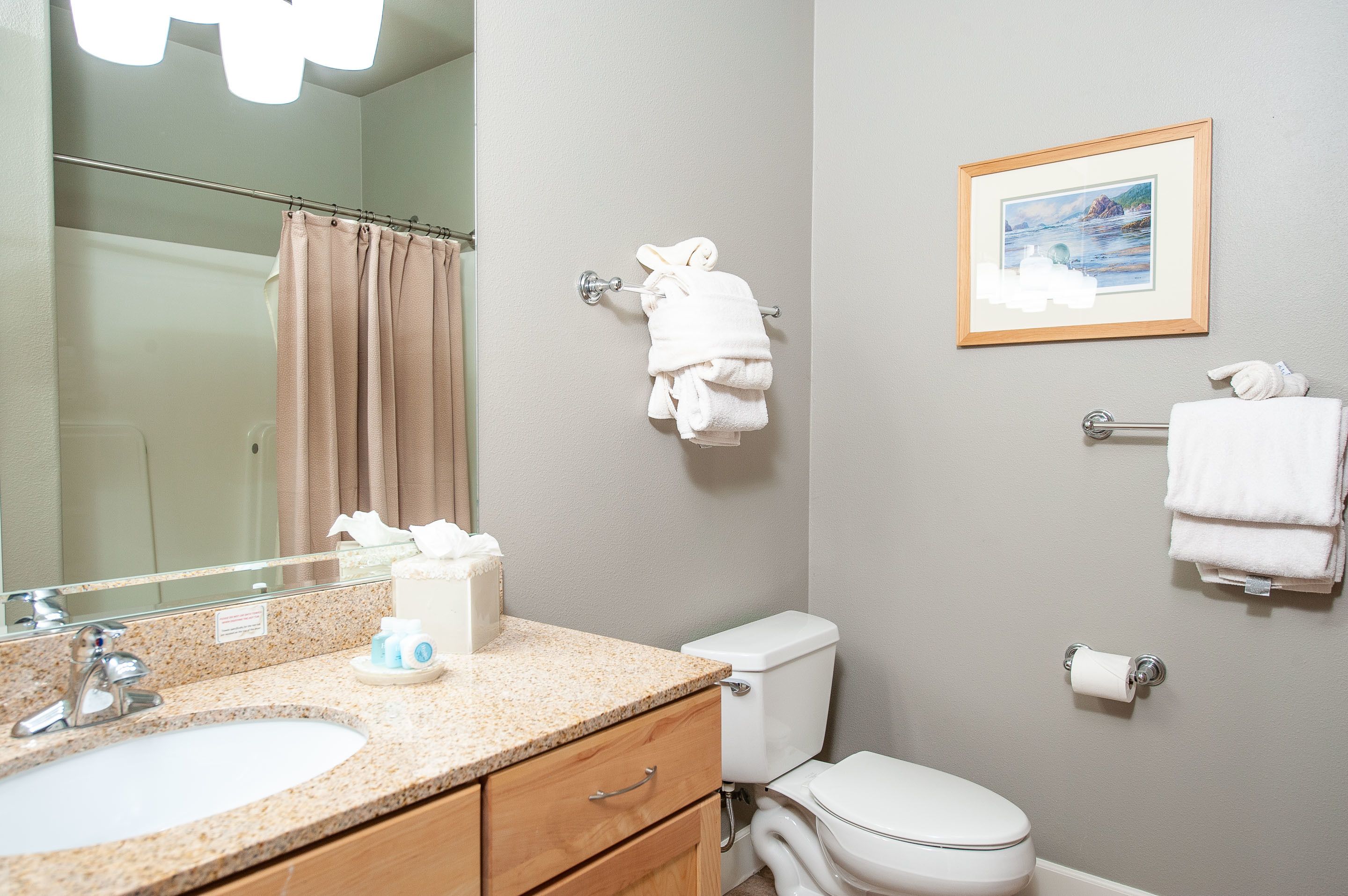 A bathroom with a sink, toilet, and towel rack.