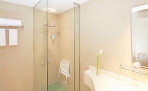 A modern bathroom with a glass-enclosed shower, a white sink, and a mirror. - ibis Styles Makkah (Makkah)