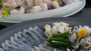 A variety of dishes on a table, including seafood and vegetables.