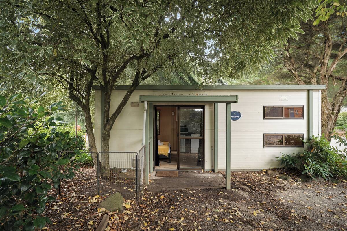 A small, single-story building with a covered entrance, a visible window, and a door.