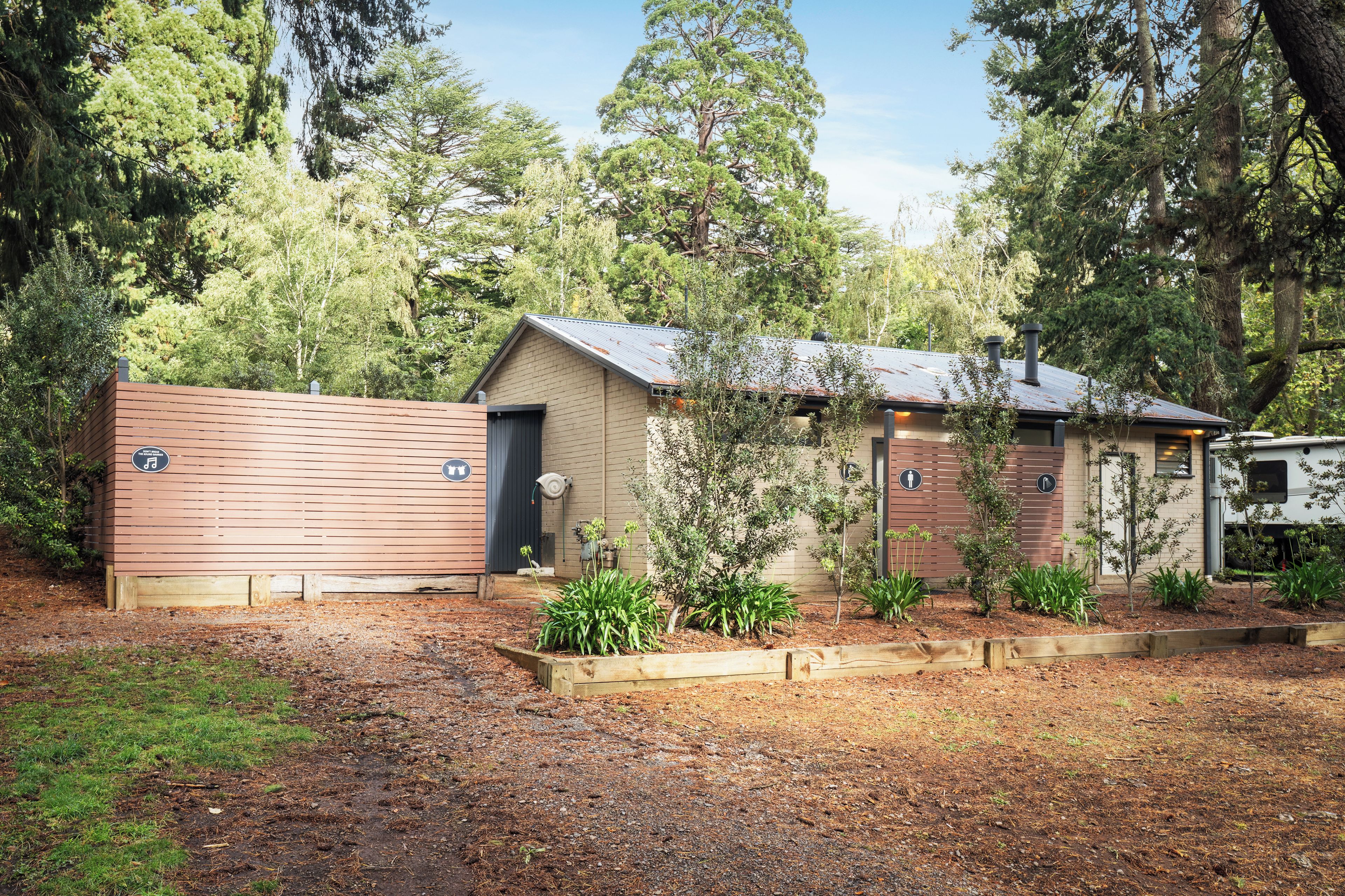 A small cabin with a sloped roof, a door, and a window.