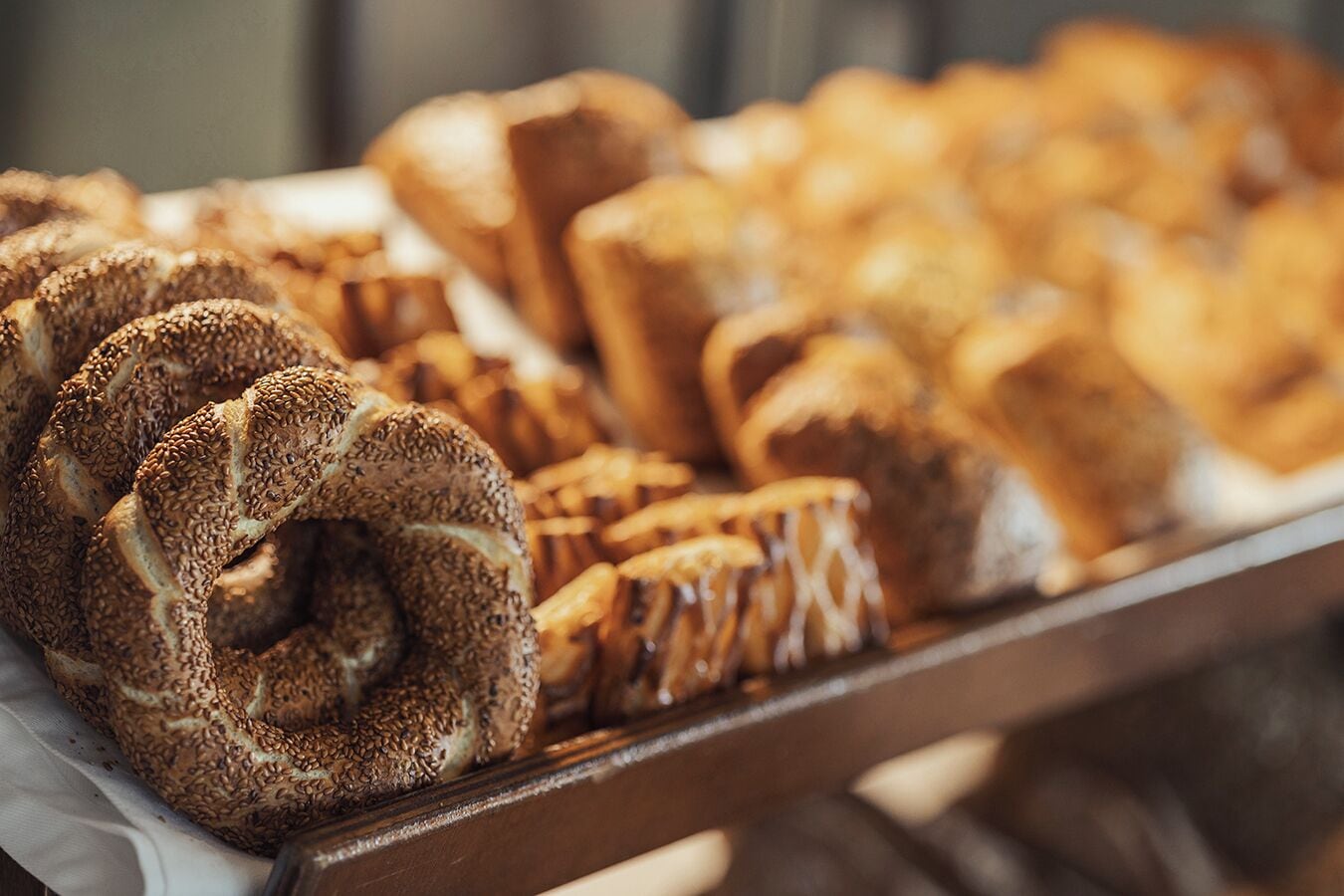 A variety of baked goods, including bread and pastries, displayed on a tray.