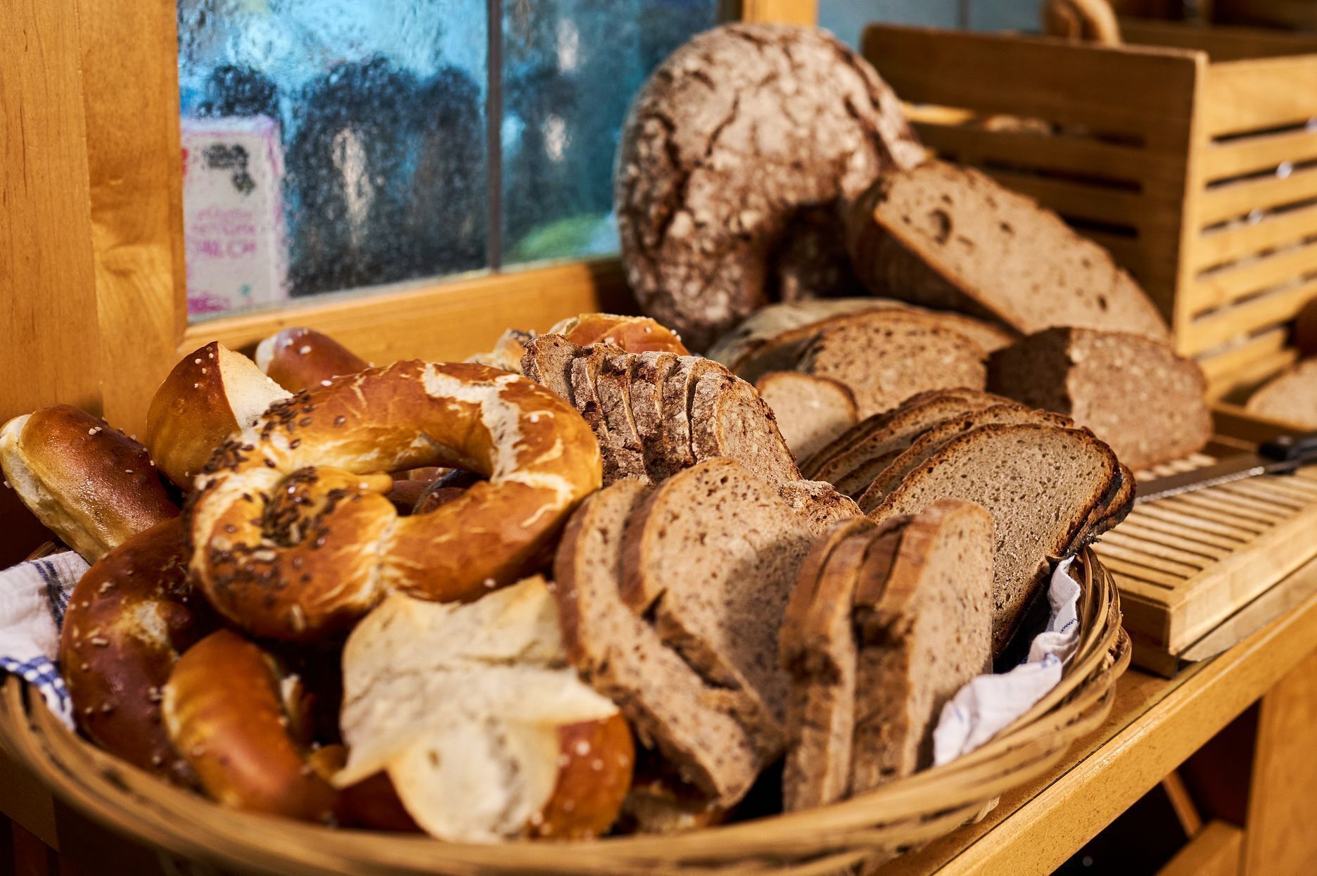A variety of breads and pastries in a basket.