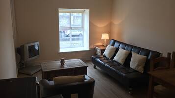 Apartment, 1 Bedroom | Living room | Flat-screen TV